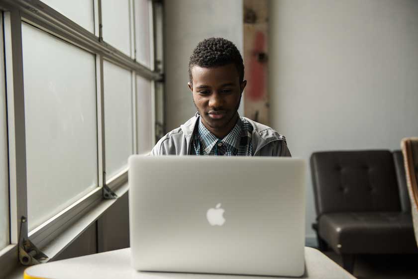young-man-laptop-by-window